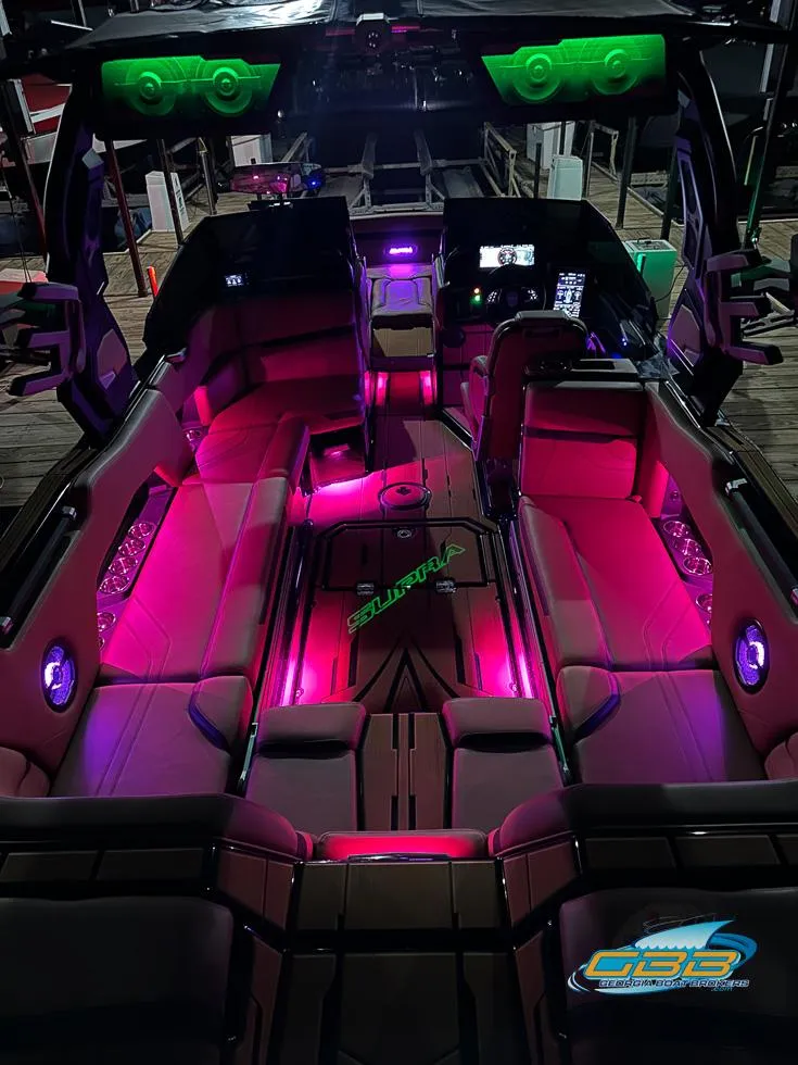 Slide: The Image of 2024 Supra SE boat interior with vibrant pink and green LED lighting. - 45
