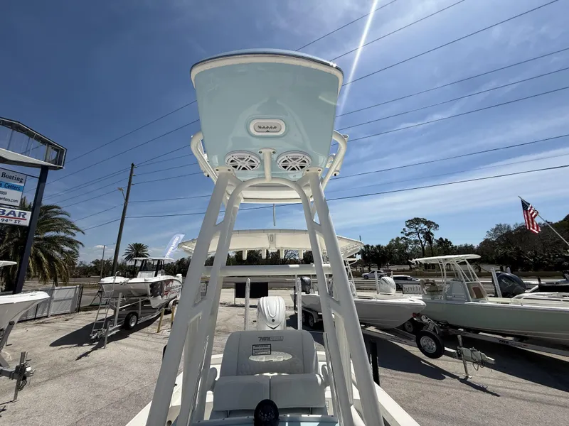 Slide: The Image of 2025 Pathfinder 2600 HPS boat with T-top and speakers, displayed outdoors under a clear sky. - 15