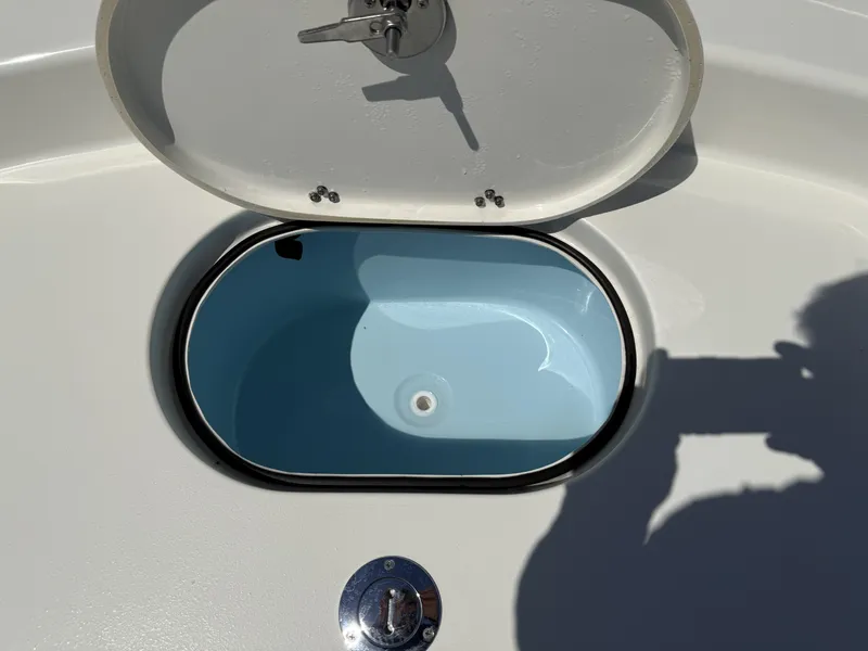 Slide: The Image of Open hatch on 2025 Pathfinder 2600 HPS boat, revealing blue interior compartment. - 20