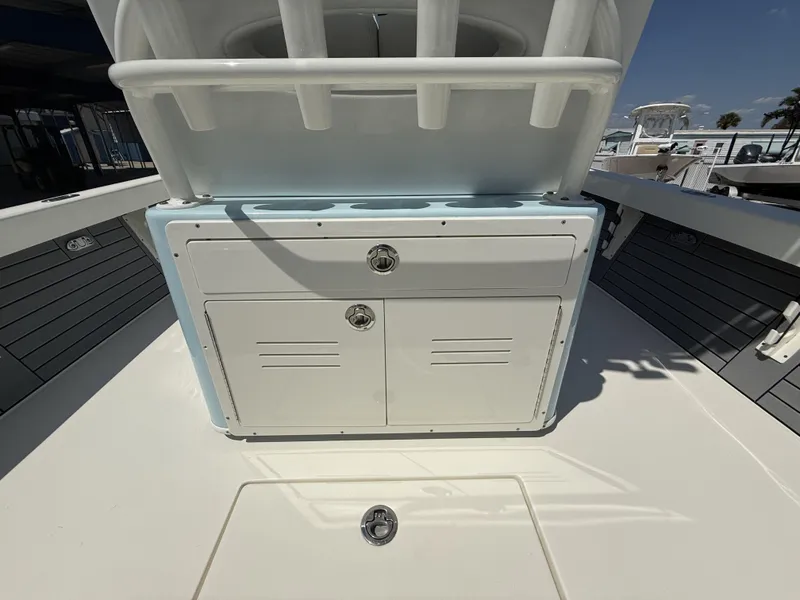 Slide: The Image of 2025 Pathfinder 2600 HPS boat console with storage compartments and rod holders. - 23