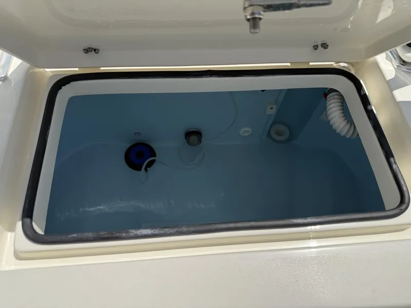 Slide: The Image of Open livewell compartment on 2025 Pathfinder 2600 HPS boat, showing interior details. - 27