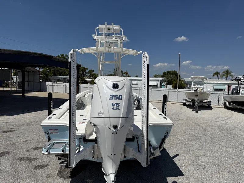 Slide: The Image of 2025 Pathfinder 2600 HPS boat with 350 V6 engine, parked outdoors under clear sky. - 4