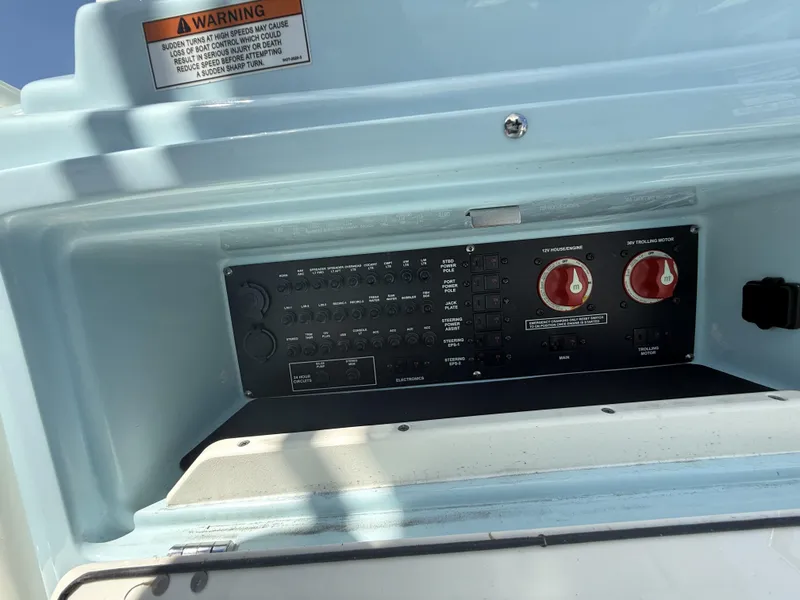 Slide: The Image of Control panel of a 2025 Pathfinder 2600 HPS boat with warning label. - 49