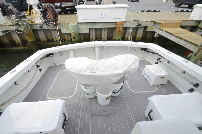 Slide: The Image of 1998 Post 42 Convertible boat deck with fishing gear and dock view. - 10