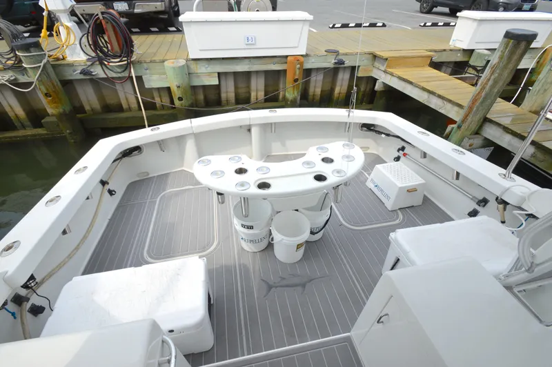 Slide: The Image of 1998 Post 42 Convertible boat deck with fishing setup at dock. - 11