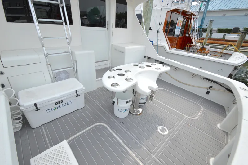 Slide: The Image of 1998 Post 42 Convertible boat deck with fishing equipment and Yeti cooler. - 13