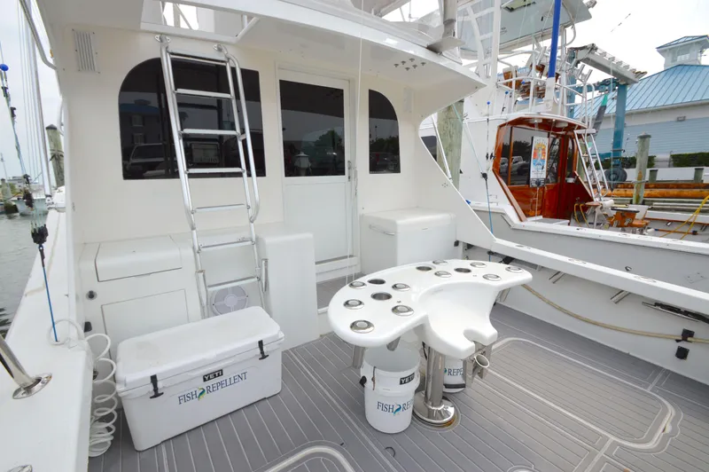 Slide: The Image of 1998 Post 42 Convertible yacht deck with fishing equipment and ladder. - 14