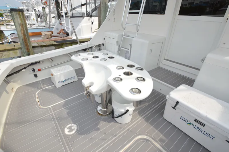 Slide: The Image of 1998 Post 42 Convertible yacht deck with fishing equipment and storage coolers. - 16