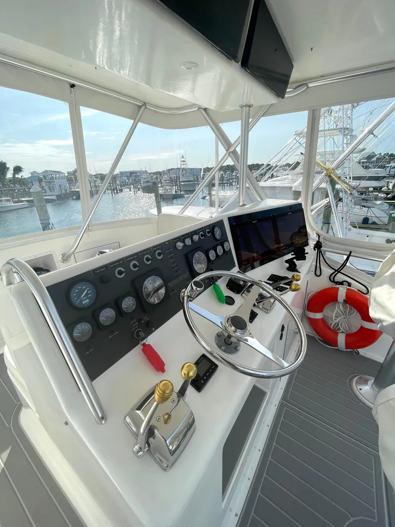 Slide: The Image of 1998 Post 42 Convertible yacht helm with steering wheel and control panel. - 22