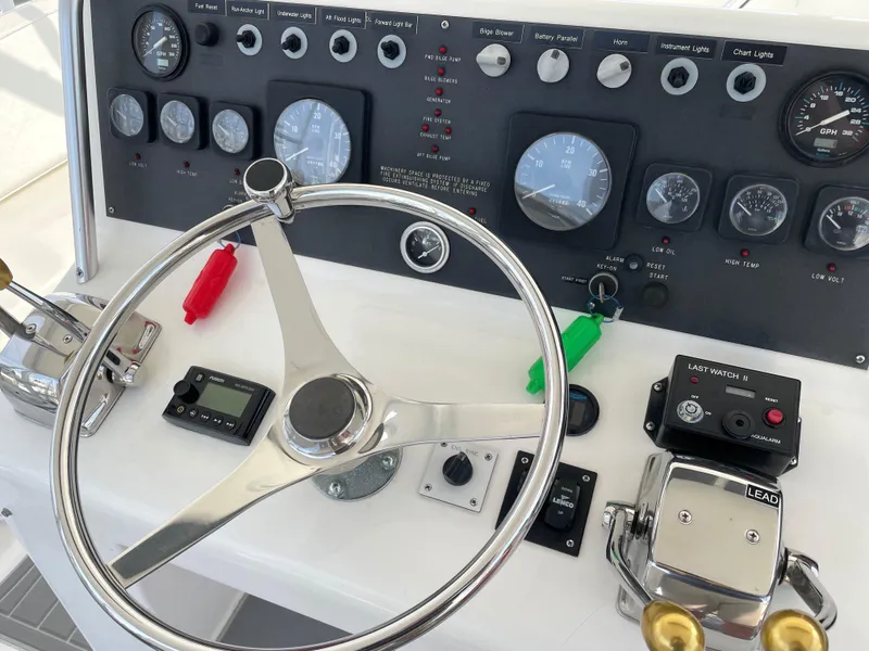 Slide: The Image of Control panel of a 1998 Post 42 Convertible boat with steering wheel and gauges. - 23