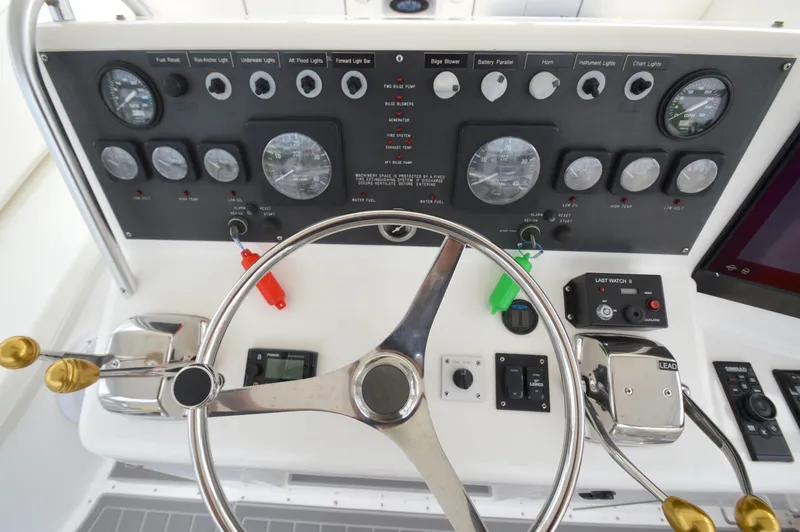 Slide: The Image of Control panel of a 1998 Post 42 Convertible yacht with steering wheel and gauges. - 27