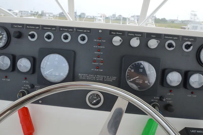 Slide: The Image of Control panel of a 1998 Post 42 Convertible boat with gauges and switches. - 28