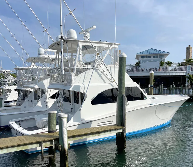 Slide: The Image of 1998 Post 42 Convertible yacht docked at marina under clear sky. - 3