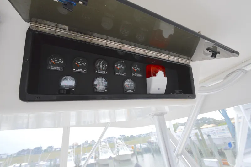 Slide: The Image of Instrument panel on 1998 Post 42 Convertible boat, featuring gauges and alarm system. - 31