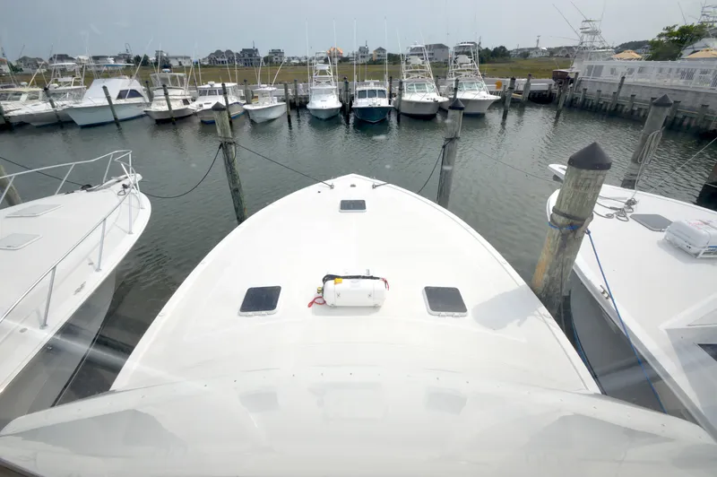 Slide: The Image of View from a 1998 Post 42 Convertible yacht docked among other boats. - 37