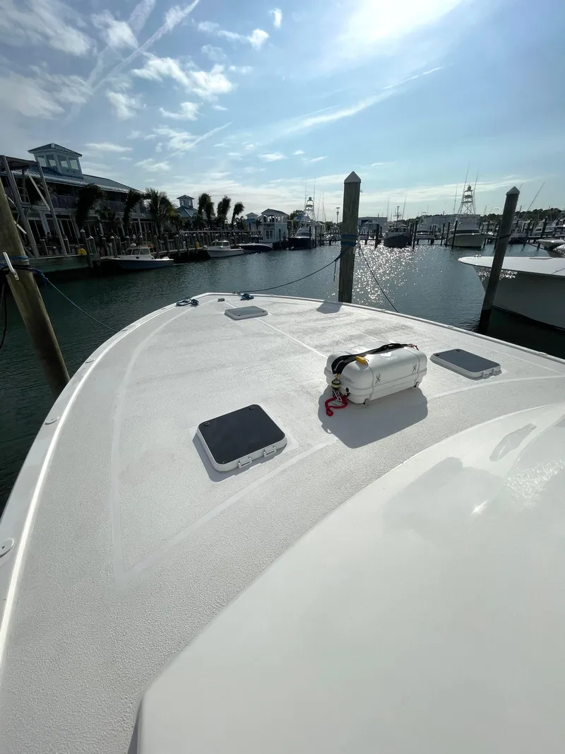 Slide: The Image of 1998 Post 42 Convertible yacht docked at marina under clear sky. - 39