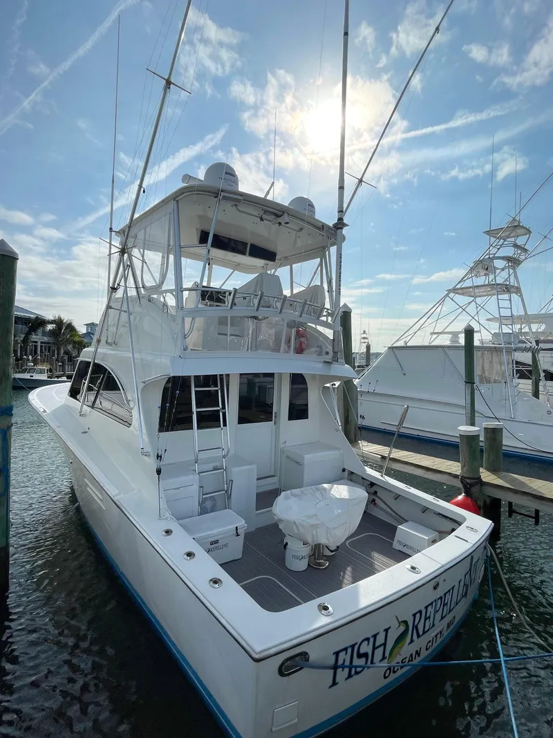 Slide: The Image of 1998 Post 42 Convertible yacht docked under a sunny sky. - 4