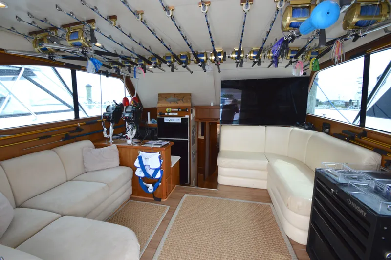 Slide: The Image of Luxurious 1998 Post 42 Convertible yacht interior with fishing rods and comfortable seating. - 44