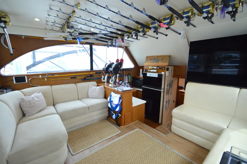 Slide: The Image of Luxurious 1998 Post 42 Convertible yacht interior with fishing rods and comfortable seating. - 46