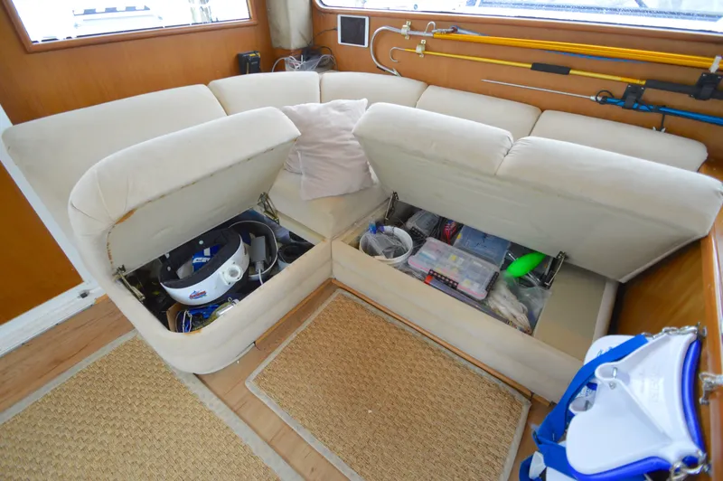 Slide: The Image of 1998 Post 42 Convertible yacht interior with storage under beige seating. - 48