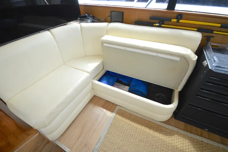 Slide: The Image of Cream leather seating with storage compartment open on a 1998 Post 42 Convertible yacht. - 49
