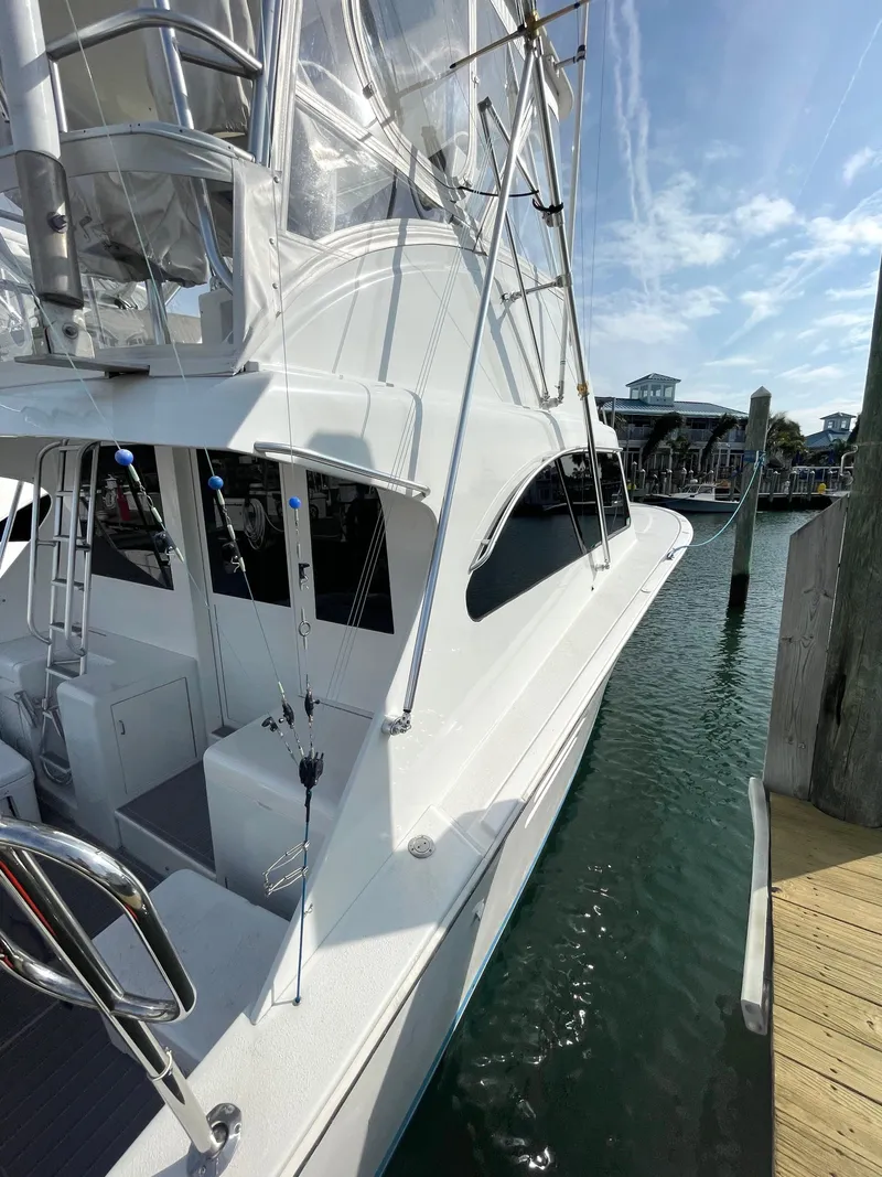 Slide: The Image of 1998 Post 42 Convertible yacht docked at marina under clear sky. - 7