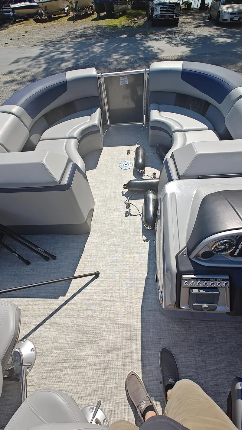 Slide: The Image of 2023 South Bay 523E 2.75 pontoon boat interior with gray seating and control panel. - 10
