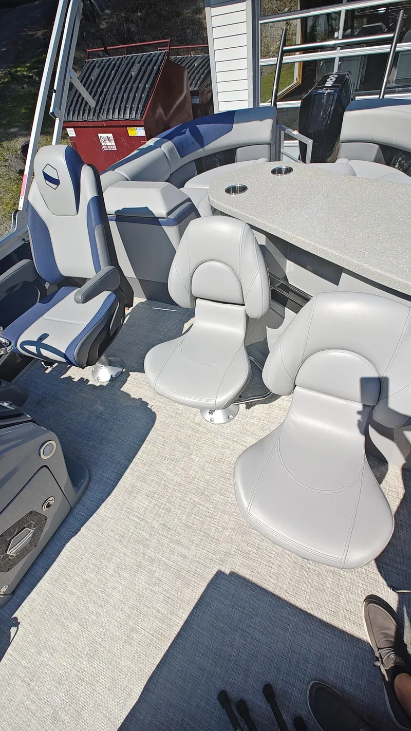 Slide: The Image of 2023 South Bay 523E 2.75 boat interior with modern seating and table. - 11
