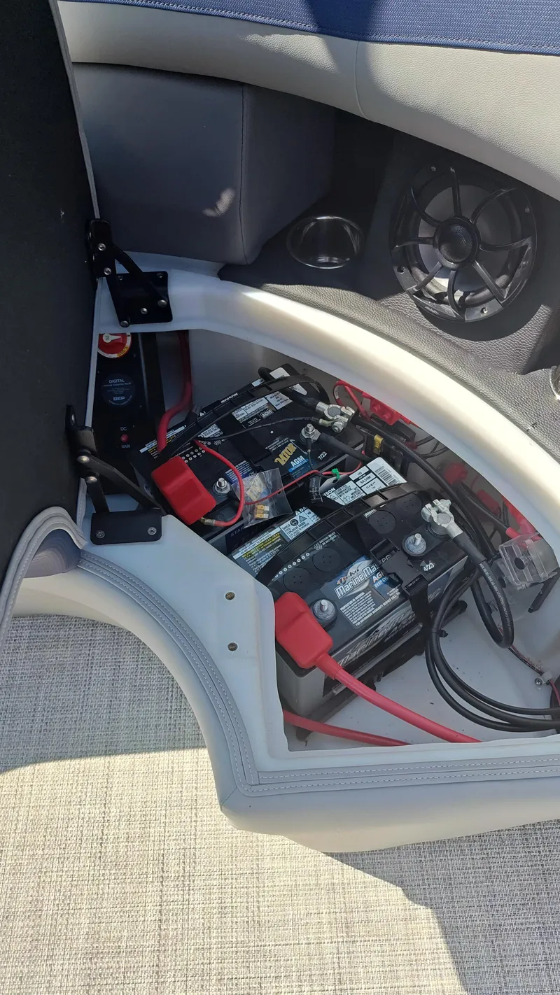 Slide: The Image of Battery compartment of 2023 South Bay 523E 2.75 boat, showing wiring and connections. - 12