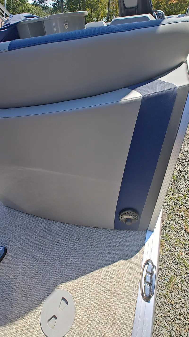 Slide: The Image of 2023 South Bay 523E 2.75 boat interior detail with gray and blue upholstery. - 14