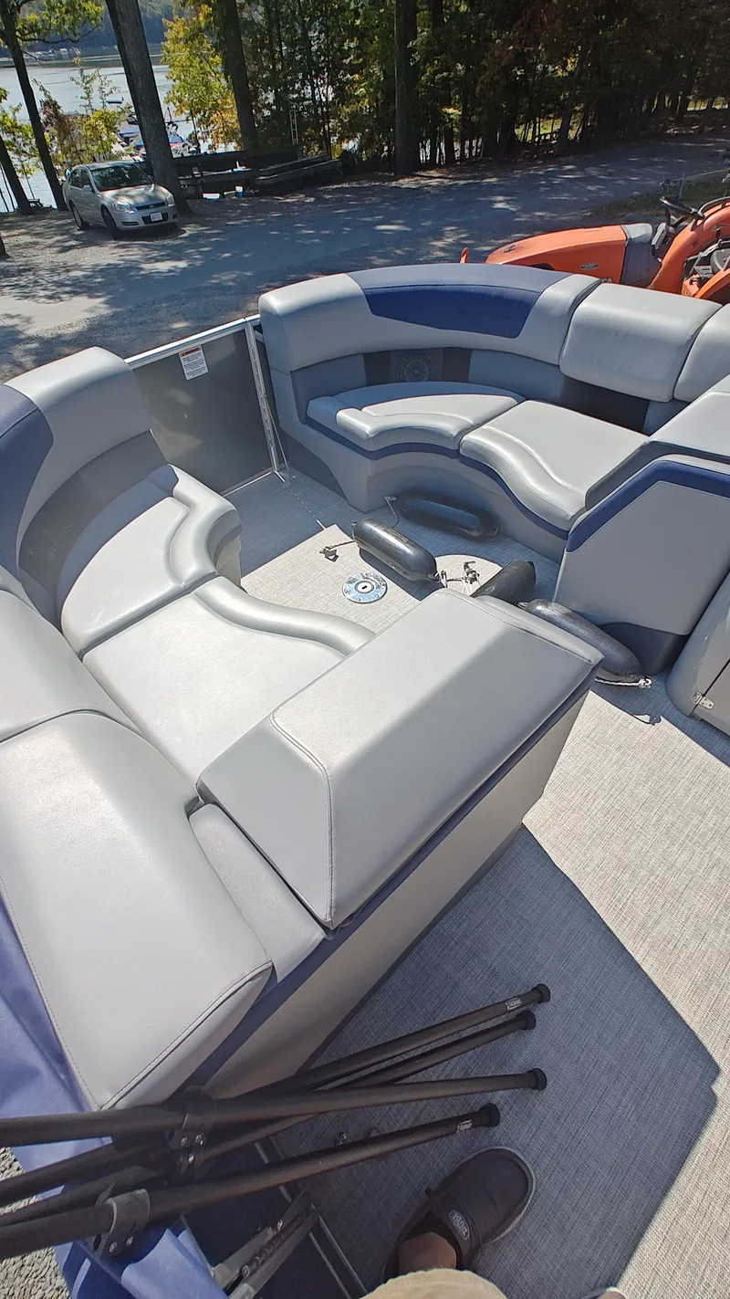 Slide: The Image of 2023 South Bay 523E 2.75 pontoon boat interior with gray and blue seating. - 16