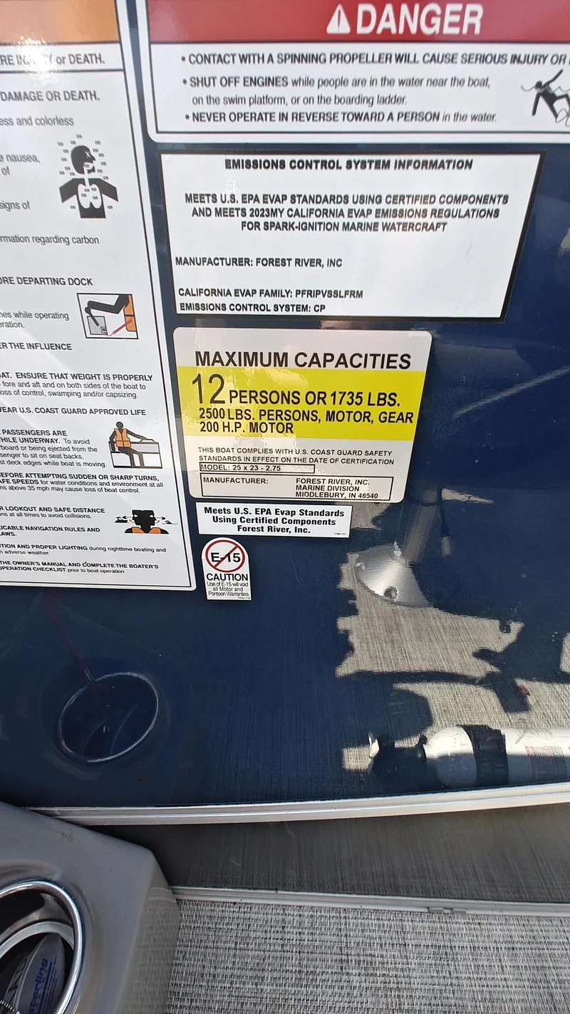 Slide: The Image of Warning labels on 2023 South Bay 523E 2.75 boat, showing maximum capacity and safety information. - 18