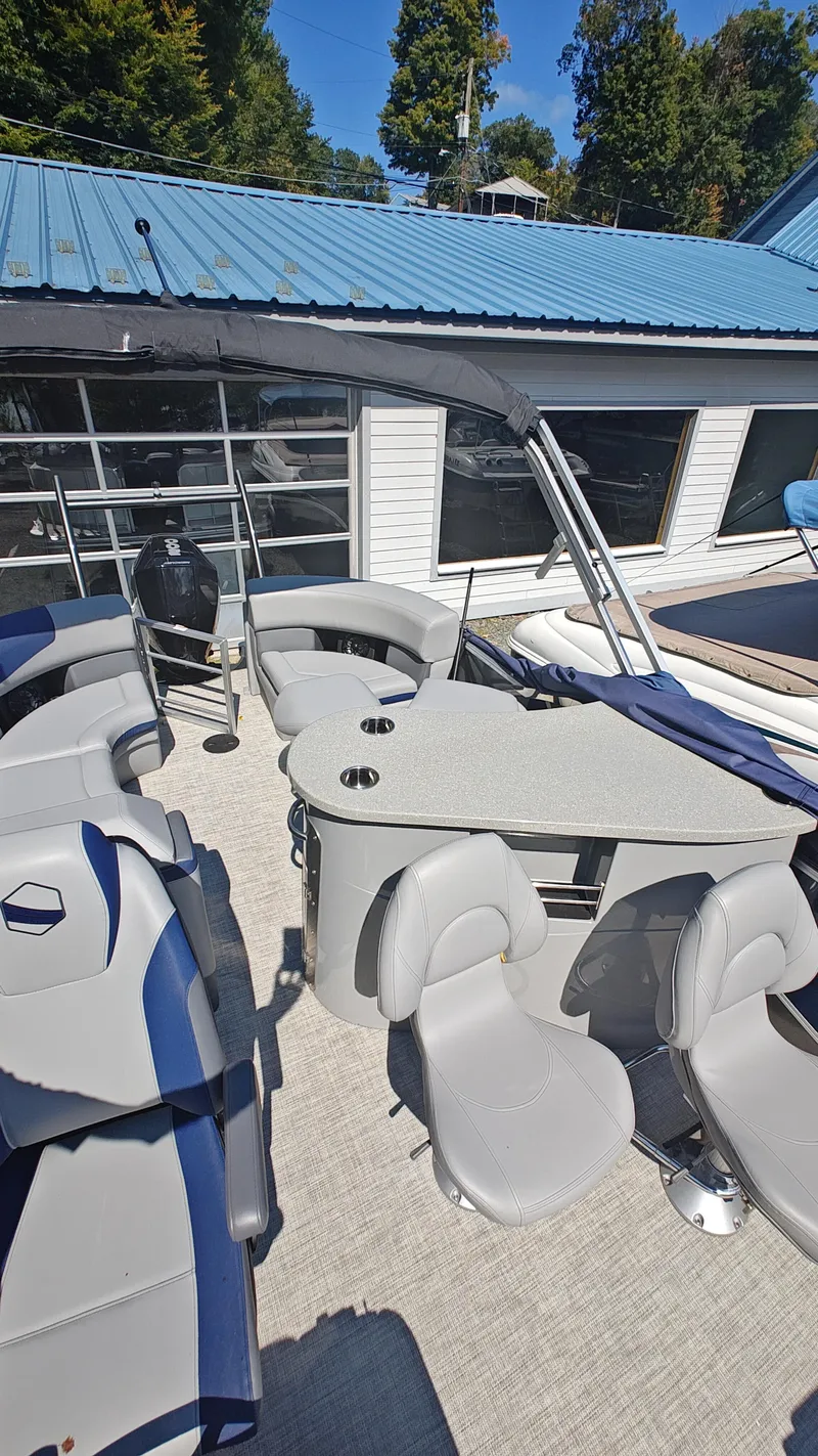 Slide: The Image of 2023 South Bay 523E 2.75 pontoon boat interior with seating and table. - 19
