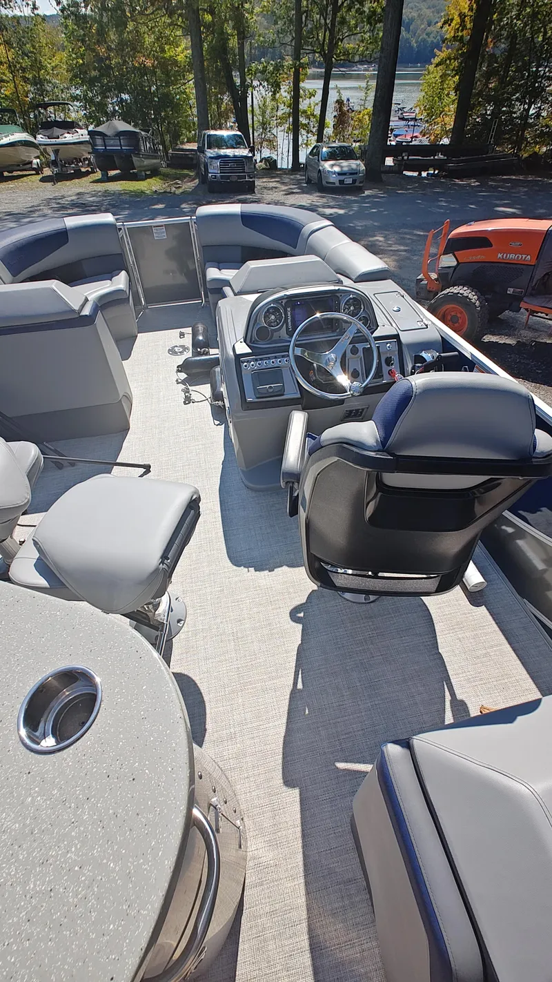 Slide: The Image of 2023 South Bay 523E 2.75 pontoon boat interior with steering console and seating. - 9