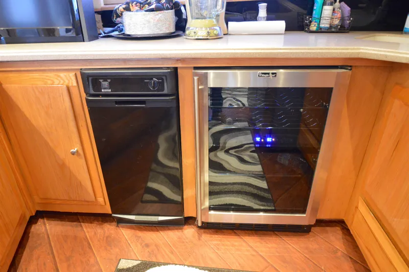 Slide: The Image of Kitchen area on 2004 Chesapeake 58 boat with dishwasher and wine cooler. - 12