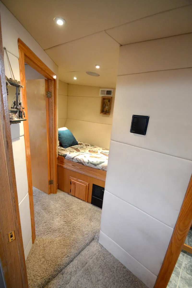 Slide: The Image of Cozy bedroom interior of 2004 Chesapeake 58 boat with soft lighting and wooden accents. - 17