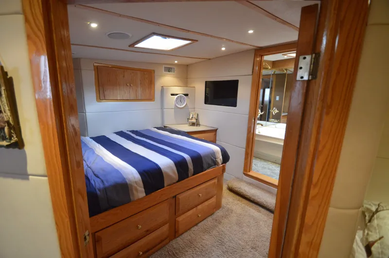 Slide: The Image of Luxurious 2004 Chesapeake 58 boat cabin with cozy bed and modern amenities. - 23
