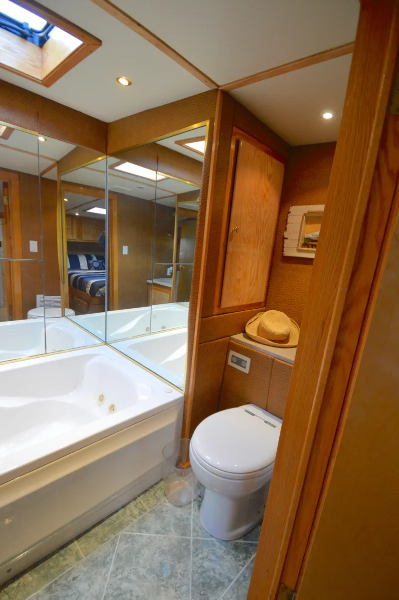 Slide: The Image of Luxurious bathroom in 2004 Chesapeake 58 boat with bathtub and wooden cabinetry. - 27