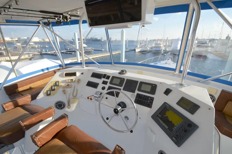 Slide: The Image of Cockpit of 2004 Chesapeake 58 boat with navigation equipment and marina view. - 28