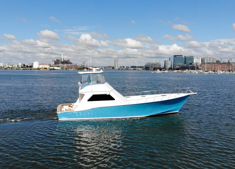 Slide: The Image of 2004 Chesapeake 58 boat cruising on a sunny day near city skyline. - 4