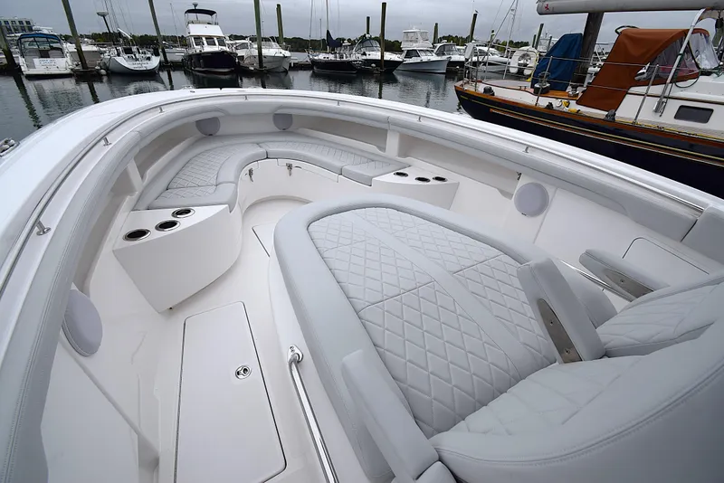 Slide: The Image of Luxurious 2023 Mag Bay 33 CC boat interior with quilted seating at marina. - 16