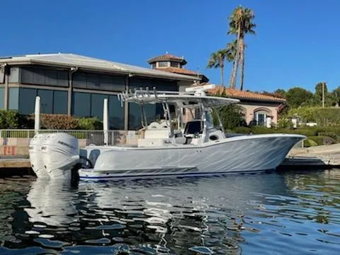 Slide: The Image of 2023 Mag Bay 33 CC boat docked by waterfront home. - 2