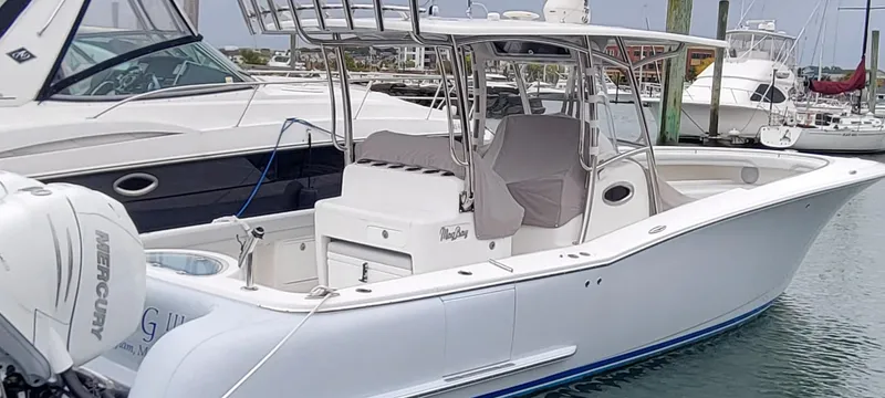 Slide: The Image of 2023 Mag Bay 33 CC boat docked in marina, featuring sleek design and powerful Mercury engine. - 25