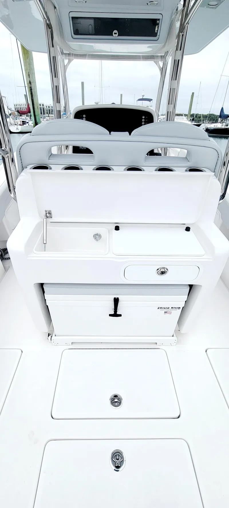 Slide: The Image of 2023 Mag Bay 33 CC boat interior with sleek white console and storage compartments. - 27