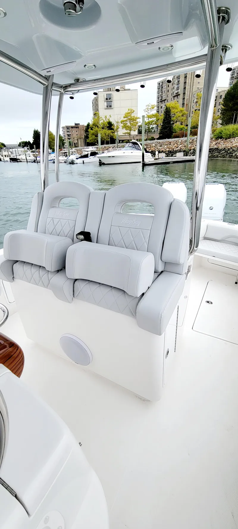 Slide: The Image of 2023 Mag Bay 33 CC boat interior with plush seating and waterfront view. - 31