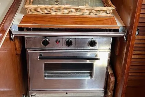 Slide: The Image of Stainless steel oven in a 1986 Pearson 36 yacht kitchen with wooden cabinetry. - 12