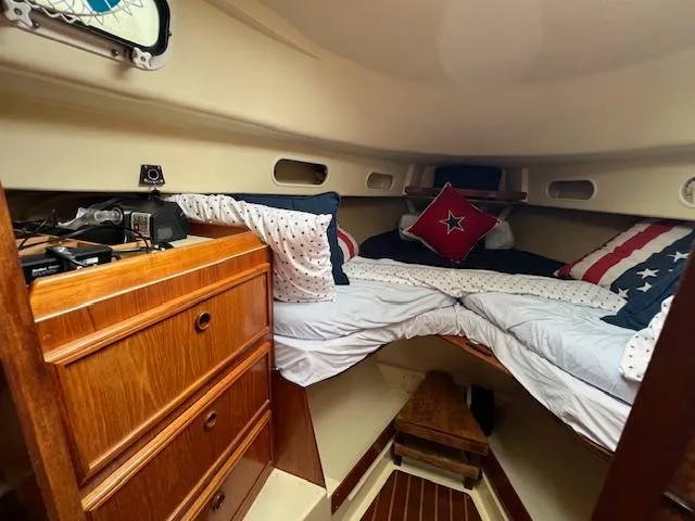 Slide: The Image of Cozy cabin interior of 1986 Pearson 36 sailboat with nautical-themed bedding. - 13