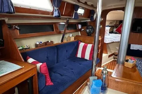 Slide: The Image of Interior of 1986 Pearson 36 sailboat with blue seating and nautical decor. - 14