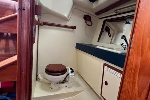 Slide: The Image of 1986 Pearson 36 yacht bathroom with wooden accents and compact design. - 15
