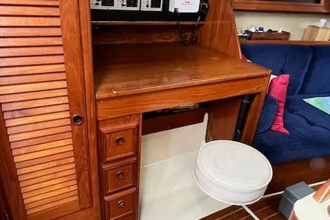 Slide: The Image of Wooden interior of 1986 Pearson 36 sailboat with desk and seating area. - 16